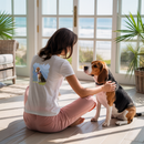 Woman sitting on the floor with a Beagle dog in a sunlit room with large windows.