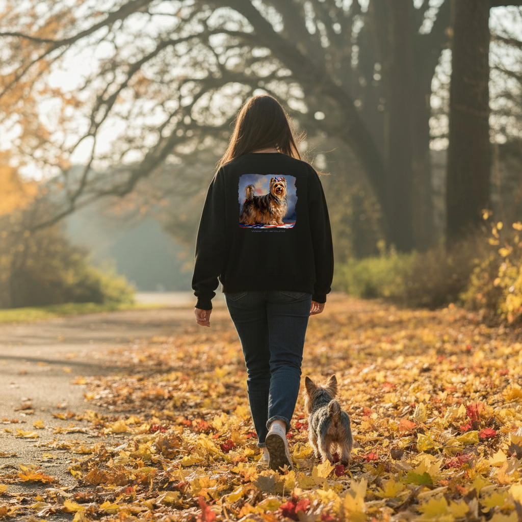 Wear-it-around Yorkshire Terrier collection image showing a young lady walking her Yorkshire Terrier along a road during the colorful fall. she is wearing a black sweatshirt featuring a Yorkshire Terrier.